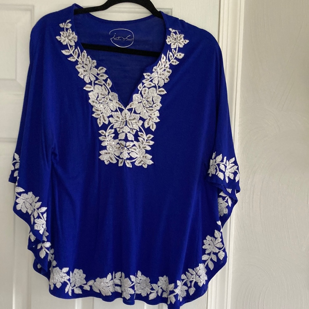 Cape style Inc top . White with silver sequin’s bright blue
